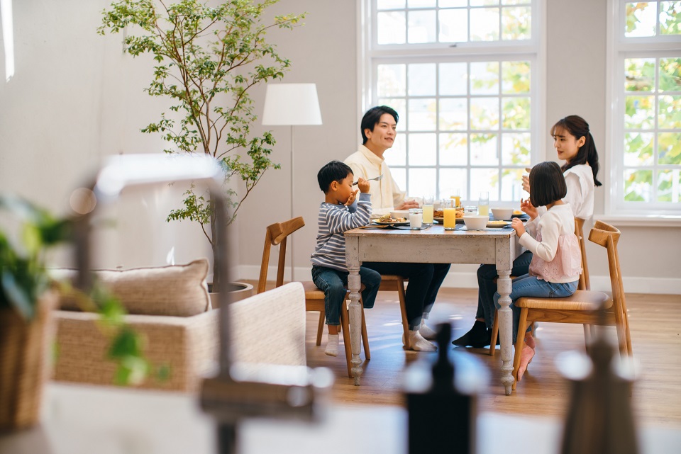明るいキッチンで家族4人が食事を楽しむ日常の暮らし